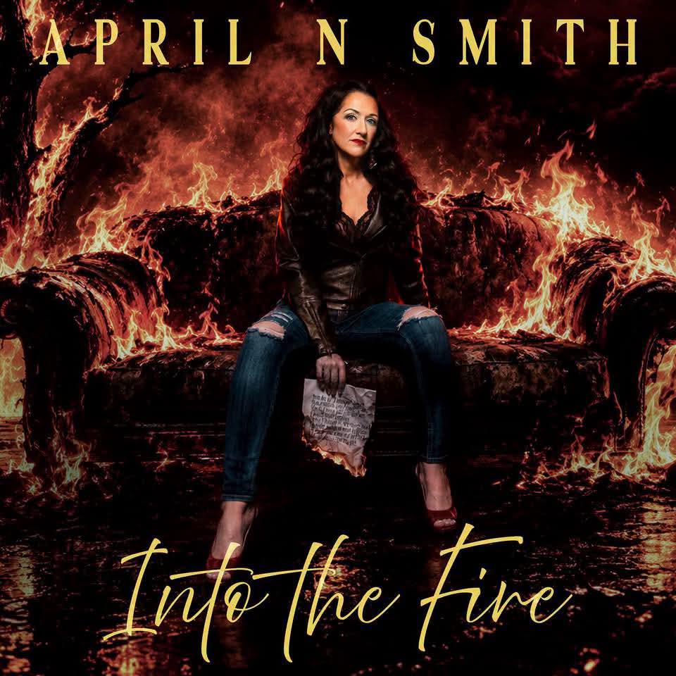 Promotional image for April N. Smith's full-band performance at Calhoun's 2.0 in Denison on Friday, August 21, 2026, featuring April N. Smith seated against a dramatic fiery background with the words Into the Fire.